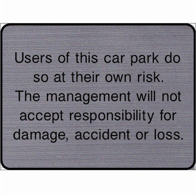 Engraved Users of this car park do so at their own risk sign