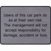 Engraved Users of this car park do so at their own risk sign