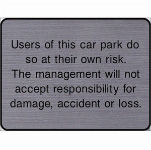 Engraved Users of this car park do so at their own risk sign