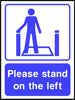 Please stand on the left escalator sign