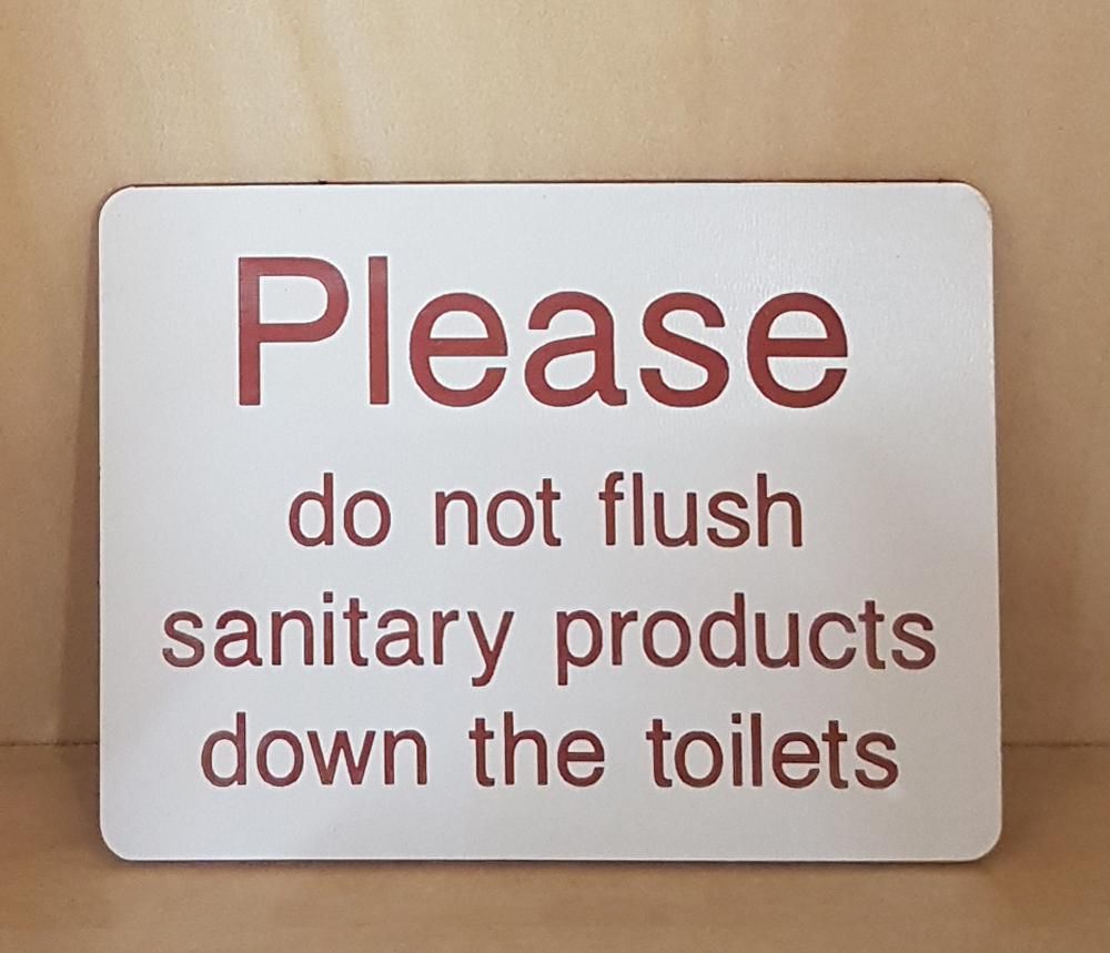 Engraved Please do not flush sanitary products sign