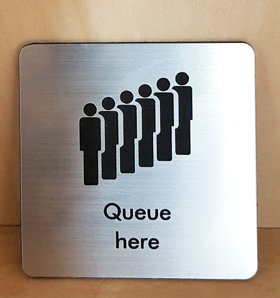 Engraved Queue here symbol sign | SK Signs & Labels | SK Signs & Labels Ltd