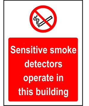 Sensitive smoke detectors operate in this building sign